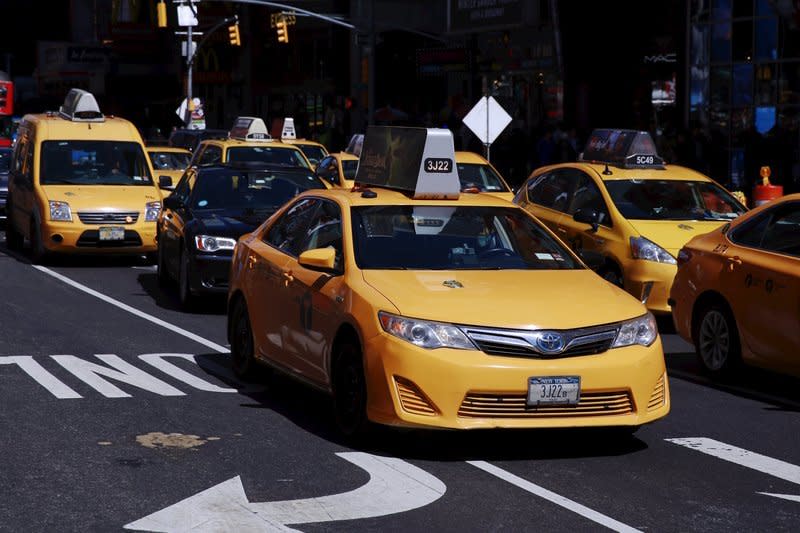 A New York City taxi cab drives through Times Square in New York March 29, 2016.  REUTERS/Lucas Jackson