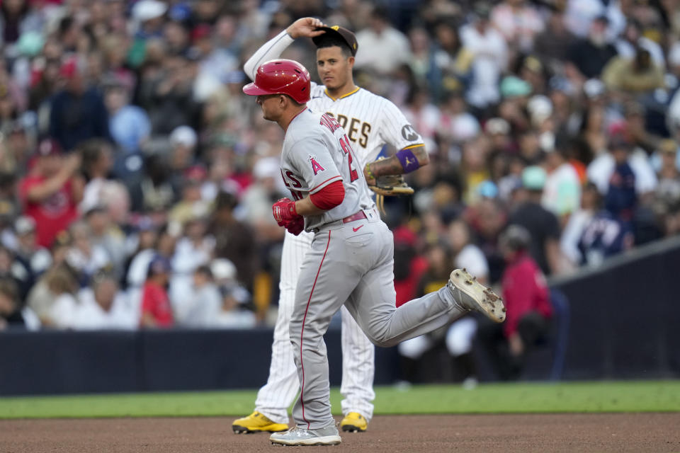Los Angeles Angels' Matt Thaiss, front, passes San Diego Padres third baseman Manny Machado as he rounds the bases after hitting a home run during the seventh inning of a baseball game Wednesday, July 5, 2023, in San Diego. (AP Photo/Gregory Bull)
