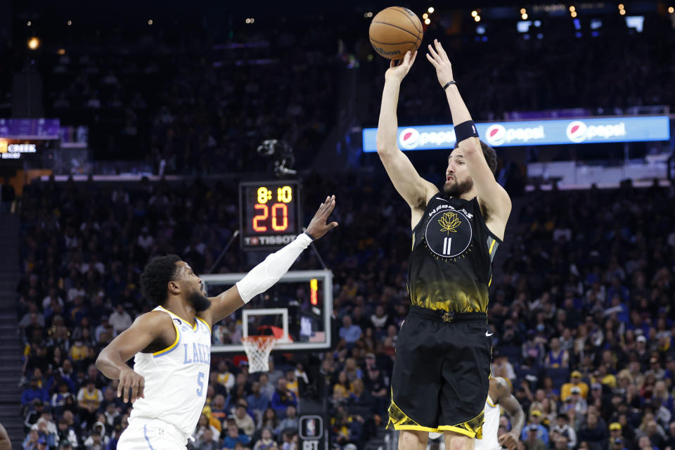Golden State Warriors guard Klay Thompson (11) shoots against Los Angeles Lakers guard Malik Beasley (5) during the first half of an NBA basketball game in San Francisco, Saturday, Feb. 11, 2023. (AP Photo/Jed Jacobsohn)