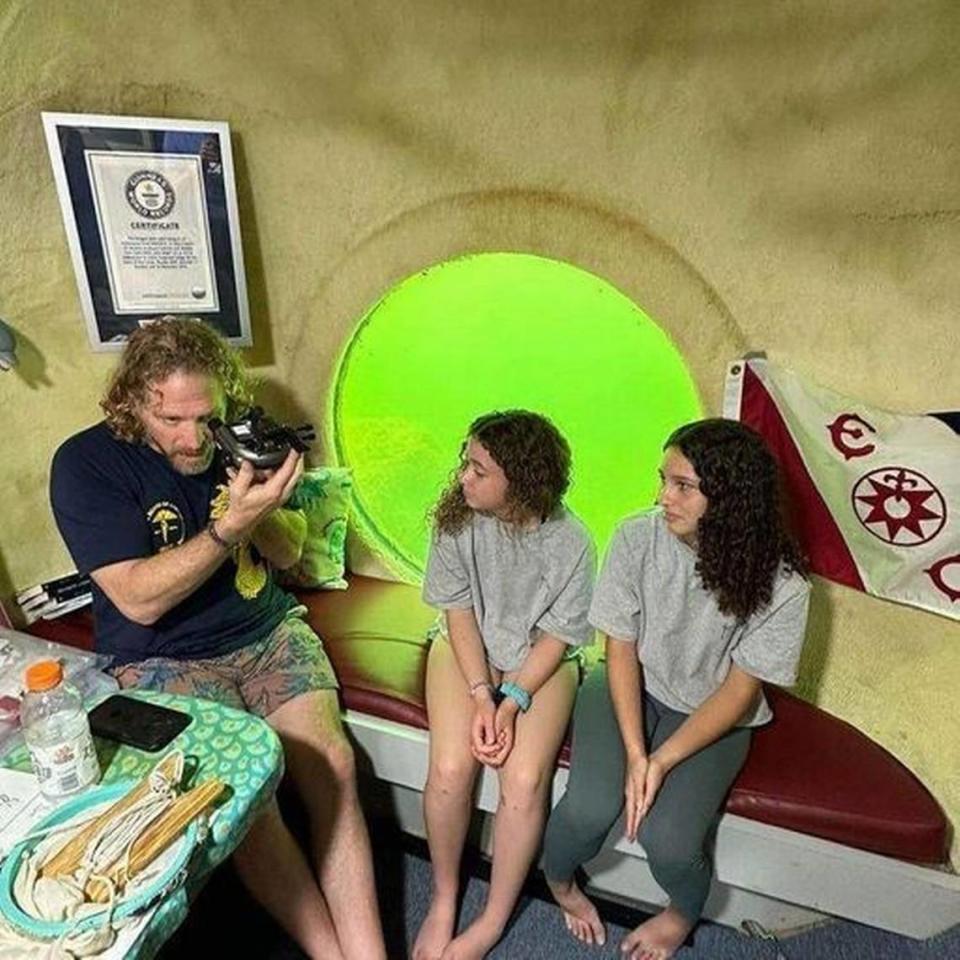 Dr. Joseph Dituri speaks with students visiting him inside Jules’ Undersea Lodge in Key Largo, where he broke the record for living the longest underwater in a fixed environment.