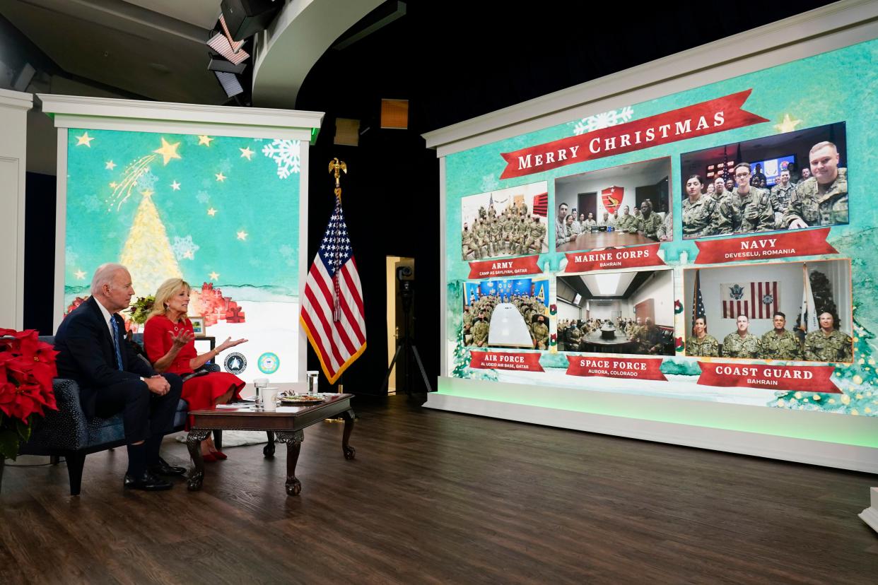 President Joe Biden, First Lady Jill Biden and their new dog Commander, a purebred German shepherd puppy, meet virtually with service members around the world on Saturday, Dec. 25, 2021, in the South Court Auditorium on the White House campus in Washington, to thank them for their service and wish them a Merry Christmas.