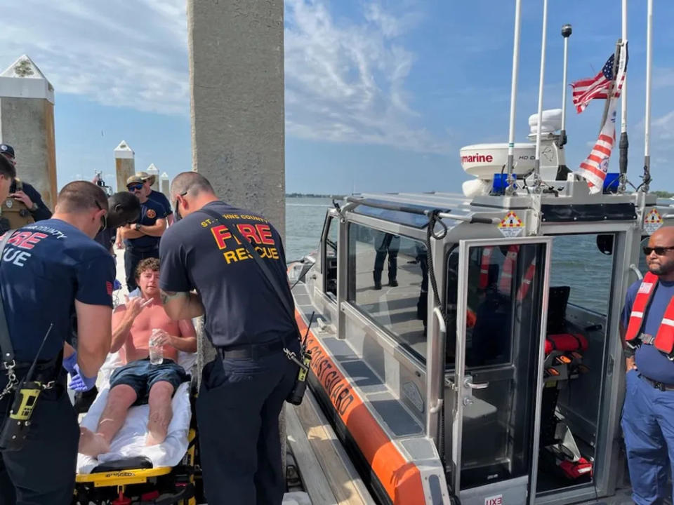 EMS transfers Charles Gregory to a local hospital after Coast Guard crews rescued him off a partially submerged 12-foot jon boat 12 miles offshore St. Augustine, Florida, Aug. 5, 2023.