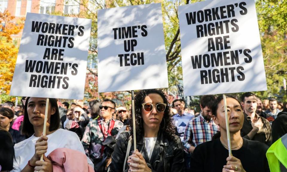 Employees hold signs outside Google’s New York office as part of the global protest.