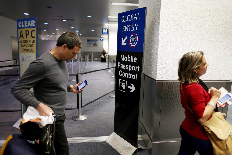 A sign points passengers to the mobile passport control window set up for international travelers.