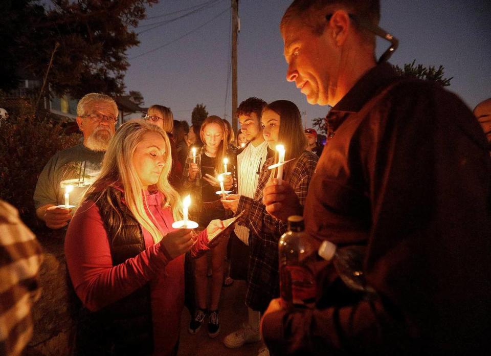 More than 250 supporters attend a candlelight vigil for Kristin Smart in front of Paul Flores’ family home in Arroyo Grande on Sunday, Nov. 17. Marie Inman, center, and her husband Chuck Inman, right, read the Lord’s Prayer to the crowd in front of the Flores family home.
