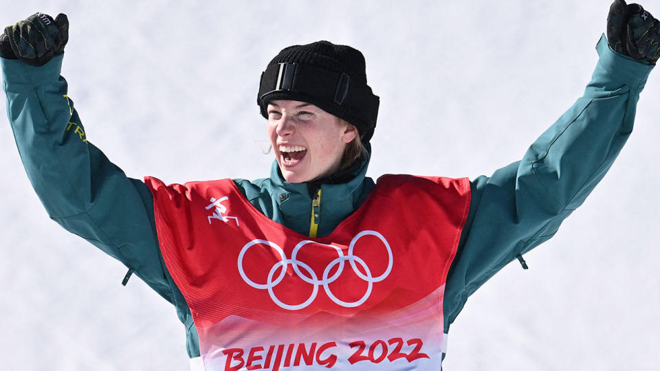 Pictured here, Aussie snowboarder Tess Coady raises her arms in triumph after claiming Olympic bronze in the women's slopestyle.