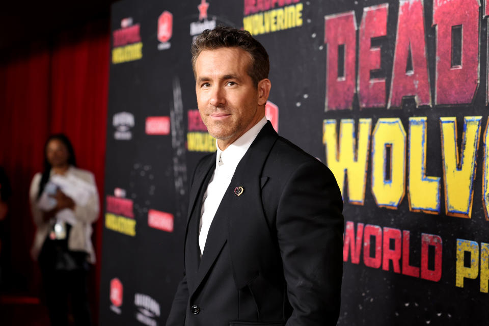 Ryan Reynolds at the red carpet premiere of "Deadpool: Wolverine," wearing a tailored suit with a white shirt underneath