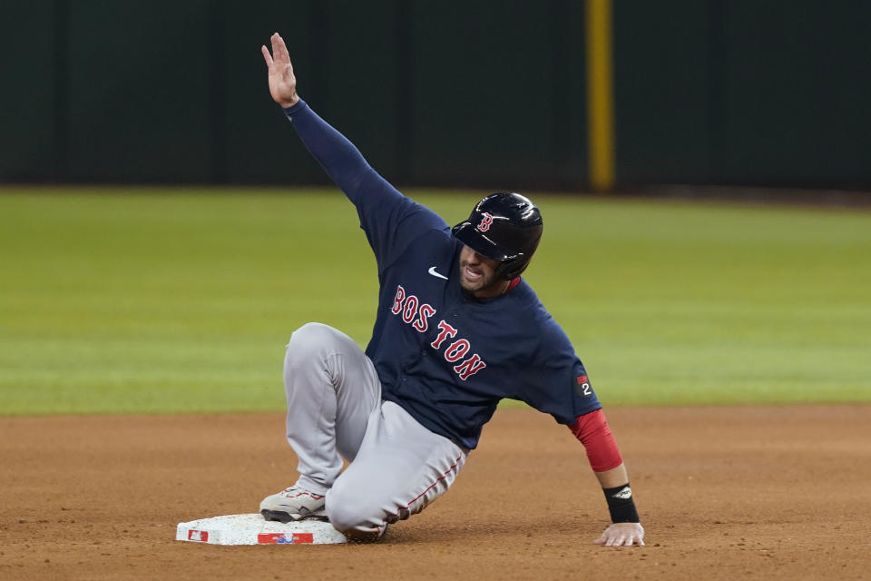 Boston Red Sox's J.D. Martinez reaches second base on a single by Xander Bogaerts during the sixth inning of the team's baseball game against the Texas Rangers in Arlington, Texas, Friday, May 13, 2022. The Red Sox won 7-1. (AP Photo/LM Otero)