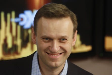 FILE PHOTO: Russian opposition leader Alexei Navalny smiles in the studio of the radio station Echo of Moscow in Moscow, Russia December 27, 2017. REUTERS/Sergei Karpukhin