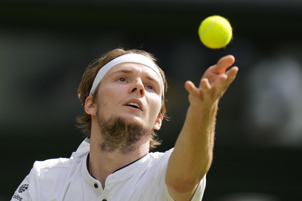 Kazakhstan's Alexander Bublik serves to Russia's Andrey Rublev in a men's singles match on day seven of the Wimbledon tennis championships in London, Sunday, July 9, 2023. (AP Photo/Kirsty Wigglesworth)