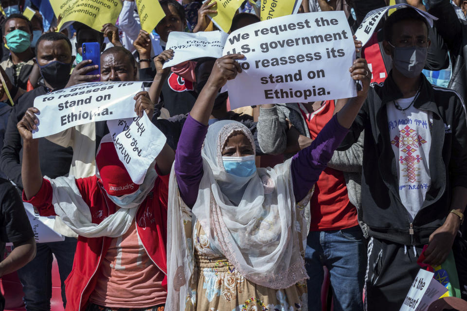 Ethiopians protest against international pressure on the government over the conflict in Tigray, at a demonstration organised by the city mayor's office held at a stadium in the capital Addis Ababa, Ethiopia Sunday, May 30, 2021. Thousands of Ethiopians gathered Sunday to protest outside pressure on the government over its brutal war in Tigray, after the U.S. said last week it has started restricting visas for government and military officials of Ethiopia and Eritrea who are seen as undermining efforts to resolve the fighting. (AP Photo/Mulugeta Ayene)
