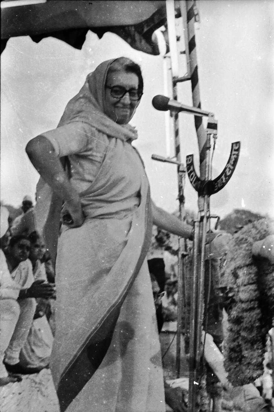 Indira Gandhi on stage with hand on hip