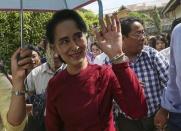 Myanmar pro-democracy leader Aung San Suu Kyi waves at supporters as she visits polling stations at her constituency Kawhmu township November 8, 2015. REUTERS/Soe Zeya Tun