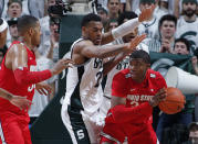 Ohio State's E.J. Liddell, right, maneuvers against Michigan State's Xavier Tillman, center, as Ohio State's Kaleb Wesson, left, watches during the first half of an NCAA college basketball game, Sunday, March 8, 2020, in East Lansing, Mich. (AP Photo/Al Goldis)