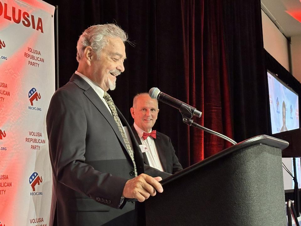 Retired Ambassador Stanley Escudero accepts a lifetime achievement award from the Volusia County Republican Party at the Ocean Center in Daytona Beach on Sunday, July 21, 2024. Behind him is Republican Party Chair Paul Deering.