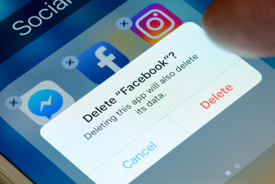 A photo of a person about to delete the Facebook app from their phone. (Photo via Getty Images)