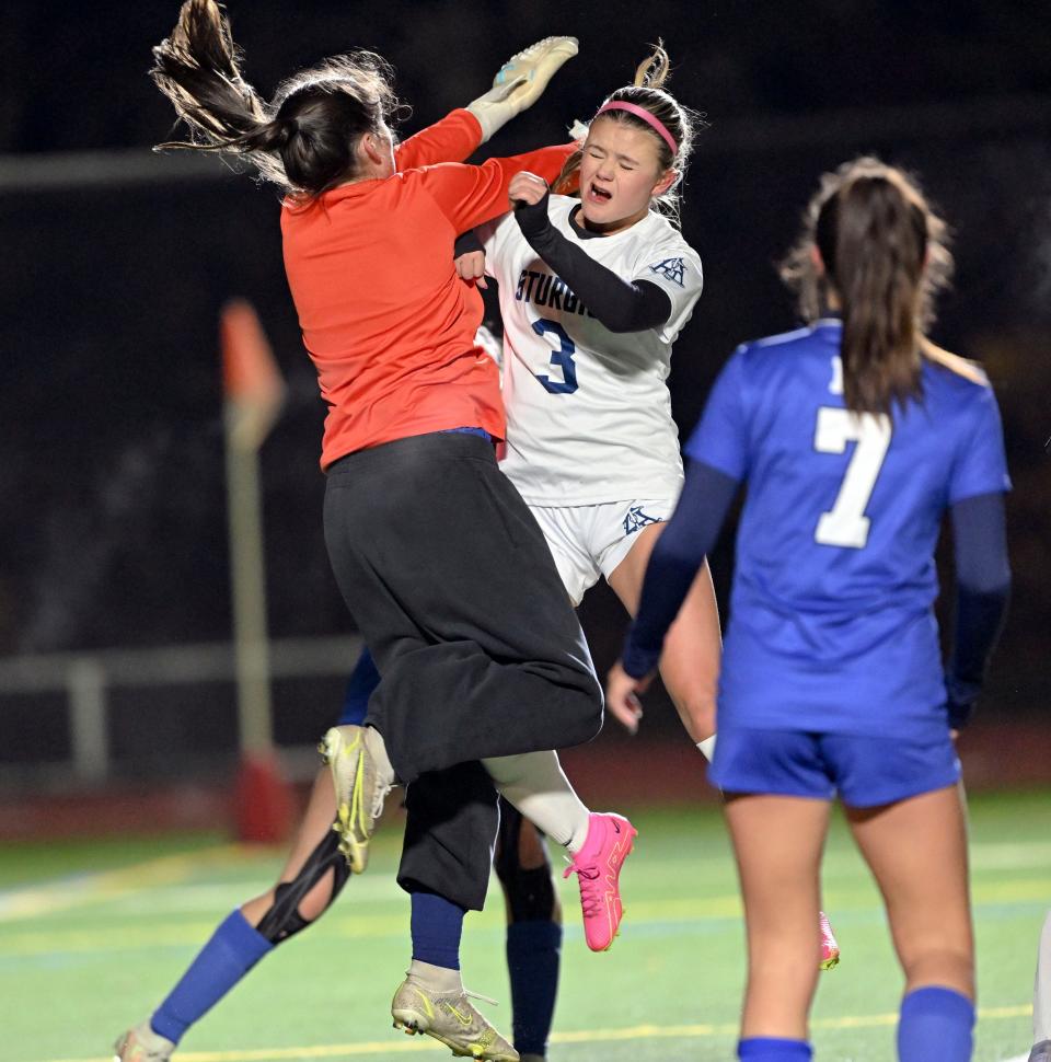 Abby Jarvis of Sturgis East collides with Mashpee goalie Norah Paolini on a corner.