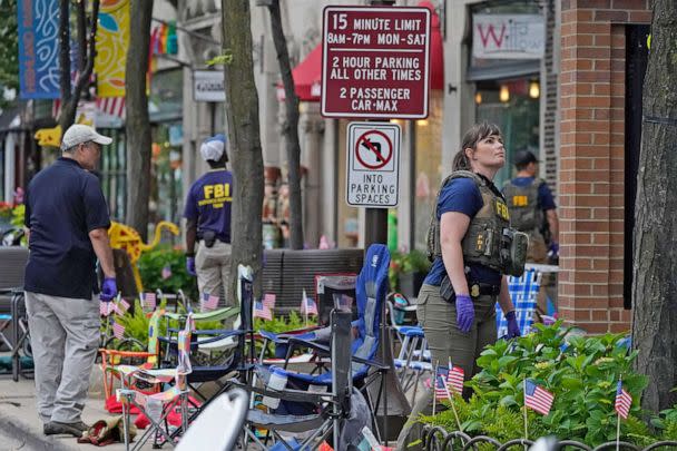 PHOTO: Law enforcement conduct a search after a mass shooting at the Highland Park Fourth of July parade in downtown Highland Park, Ill., a Chicago suburb on July 4, 2022.   (Nam Y. Huh/AP, FILE)