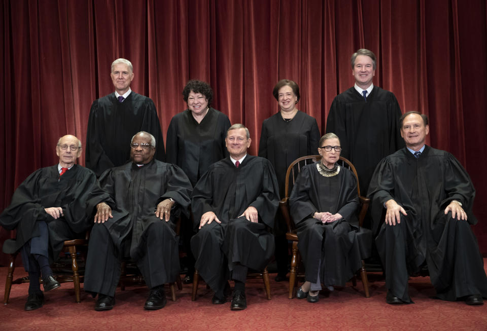 FILE - In this Nov. 30, 2018, file photo, the justices of the U.S. Supreme Court gather for a formal group portrait to include the new Associate Justice, top row, far right, at the Supreme Court building in Washington. Seated from left: Associate Justice Stephen Breyer, Associate Justice Clarence Thomas, Chief Justice of the United States John G. Roberts, Associate Justice Ruth Bader Ginsburg and Associate Justice Samuel Alito Jr. Standing behind from left: Associate Justice Neil Gorsuch, Associate Justice Sonia Sotomayor, Associate Justice Elena Kagan and Associate Justice Brett M. Kavanaugh. On Monday, May 4, 2020, the Supreme Court for the first time audio of court's arguments will be heard live by the world and the first arguments by telephone. (AP Photo/J. Scott Applewhite, File)