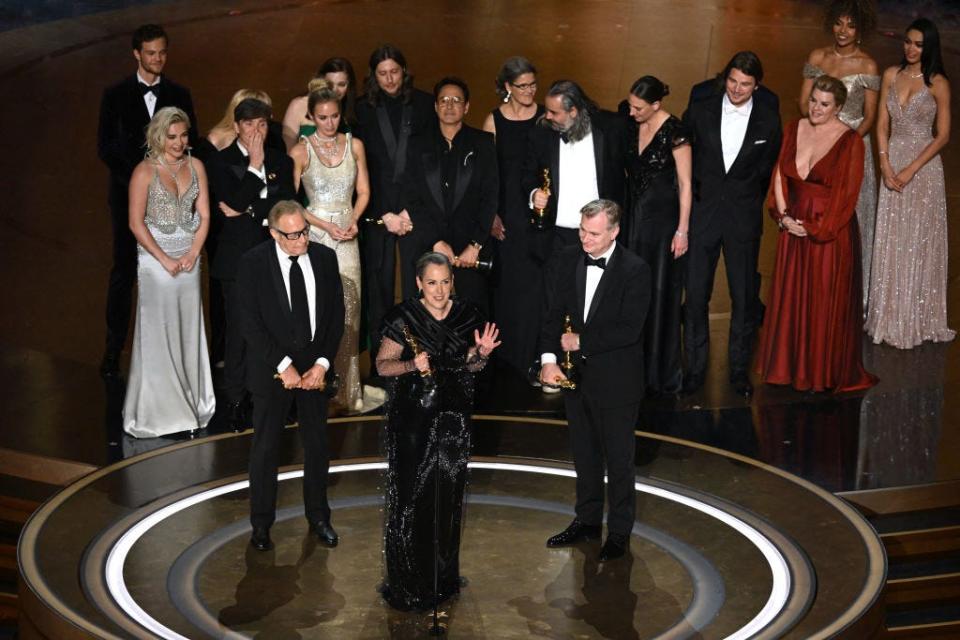 The Oppenheimer cast and crew onstage accepting the award for best picture.