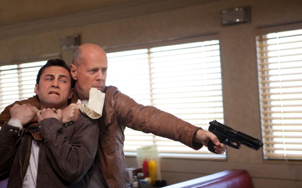 Bruce Willis totes the guns in Looper - Alan Markfield