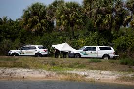 Investigators at the site near Naples, Florida, where Neil Clark's body was found.