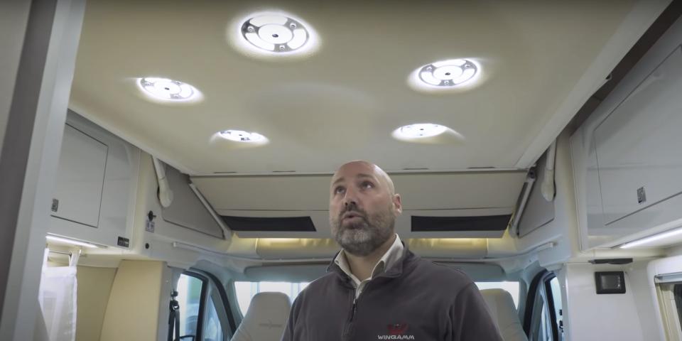 a person looking up at the overhead lights
