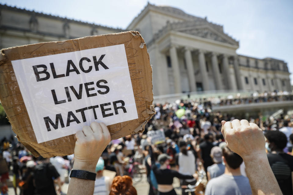 FILE - In this Friday, June 19, 2020 file photo, a protester holds a sign that reads "BLACK LIVES MATTER" during a Juneteenth rally outside the Brooklyn Museum, in the Brooklyn borough of New York. Juneteenth commemorates when the last enslaved African Americans learned they were free 155 years ago. Belarusian opposition figures, Hong Kong-pro-democracy activists, the Black Lives Matter movement, a jailed Russian opposition leader and two former White House senior advisers are among this year’s nominations for the Nobel Peace Prize. The 2021 deadline has passed and some of those who nominated people have spoken up. (AP Photo/John Minchillo, File)