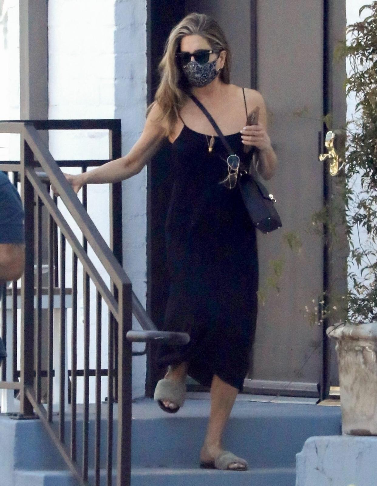 Jennifer Aniston wearing fuzzy slides