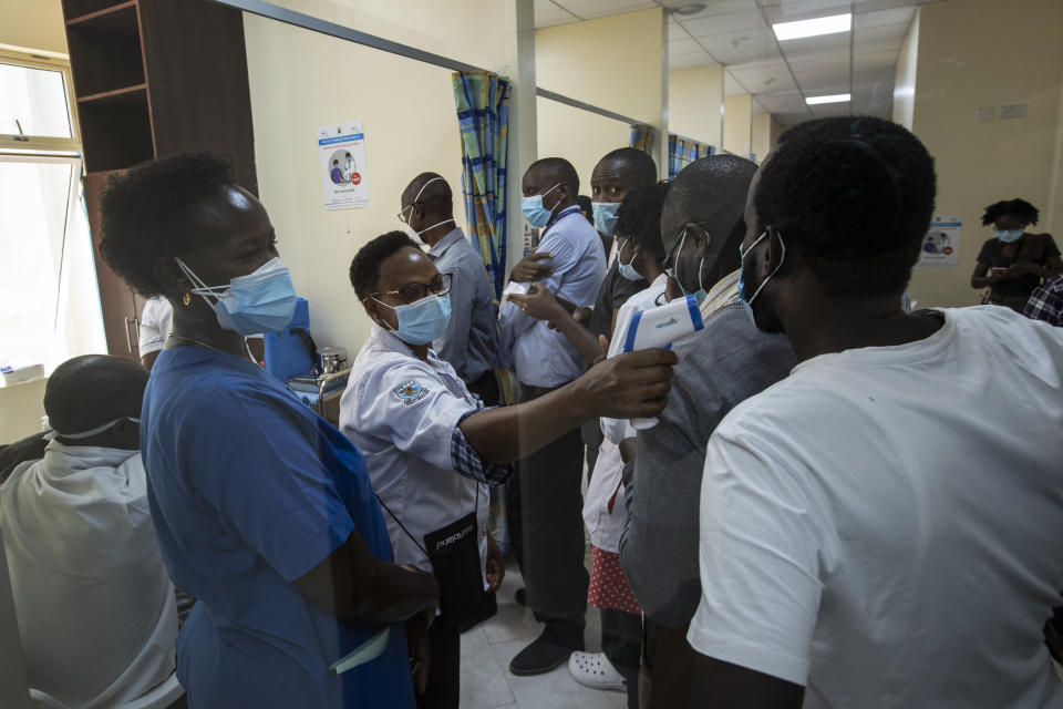 Medical staff wait in line to receive some of the country's first coronavirus vaccinations using AstraZeneca COVID-19 vaccine manufactured by the Serum Institute of India and provided through the global COVAX initiative, at Kenyatta National Hospital in Nairobi, Kenya Friday, March 5, 2021. Urgent calls for COVID-19 vaccine fairness rang through African countries on Friday as more welcomed or rolled out doses from the global COVAX initiative, with officials acutely aware their continent needs much more. (AP Photo/Ben Curtis)