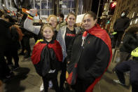 Amanda Hill, right, attends a protest with family members in Sydney, Tuesday, June 2, 2020, to support the cause of U.S. protests over the death of George Floyd and urged their own governments to address racism and police violence. Floyd died last week after he was pinned to the pavement by a white police officer who put his knee on the handcuffed black man's neck until he stopped breathing. (AP Photo/Rick Rycroft)