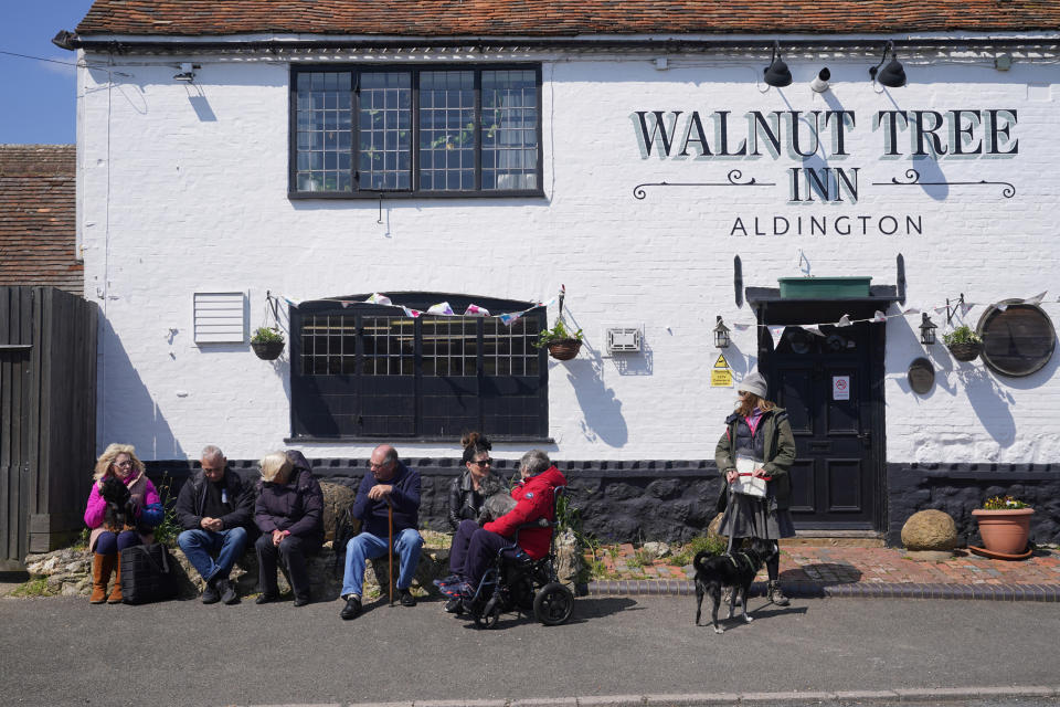 Well wishers wait outside the Walnut Tree Pub in Aldington, Kent, for the funeral cortege of Paul O'Grady to pass by on its way to his funeral service at St Rumwold's Church. Picture date: Thursday April 20, 2023. (Photo by Yui Mok/PA Images via Getty Images)