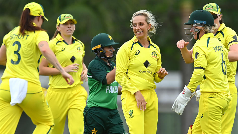 Ashleigh Gardner is pictured centre as Australian teammates rush to congratulate her on a wicket.