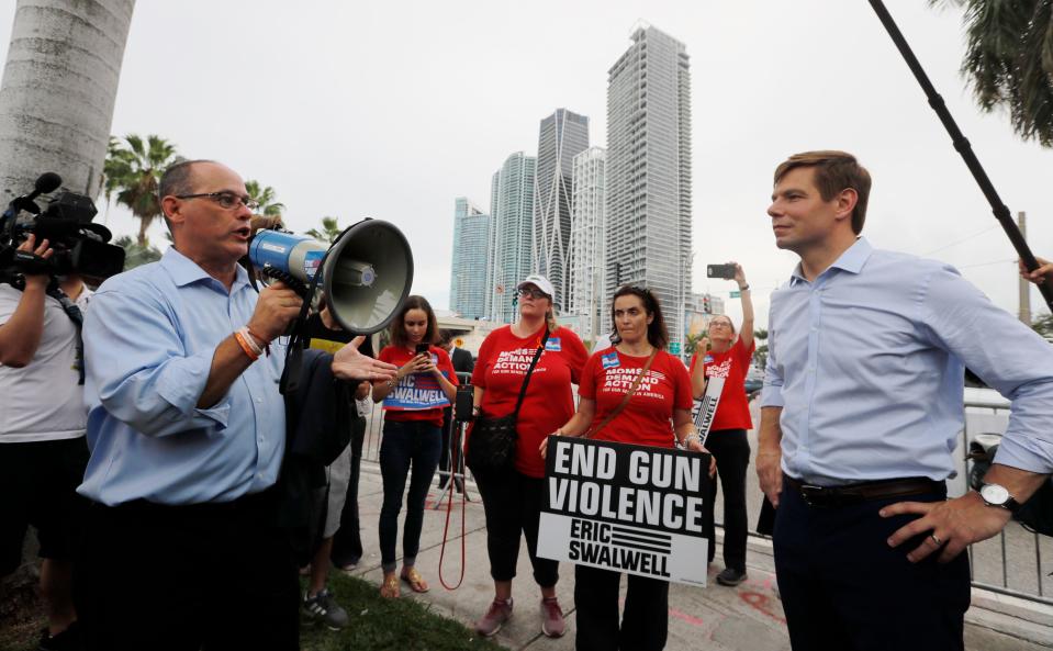 In this June 27, 2019, file photo, Fred Guttenberg, left, the father of Parkland victim Jaime Guttenberg, speaks to Eric Swalwell, one of the candidates debating during the Democratic debate at the Adrienne Arsht Center in Miami. Swalwell supports gun control and wants to end gun violence.