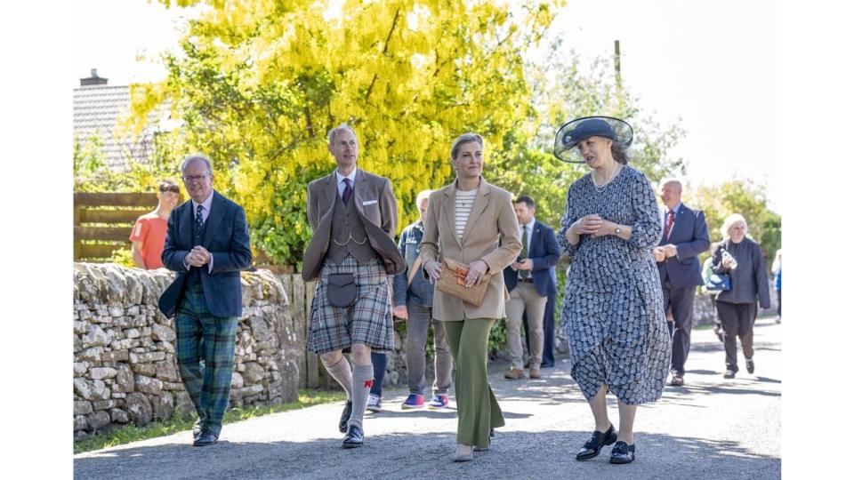 The Duke and Duchess of Edinburgh walk through the village with Lord Lieutenant Patrick Marriott (left) and Chair of Golspie Community Council Henrietta Marriott (right) during a visit to Golspie, Sutherland. 