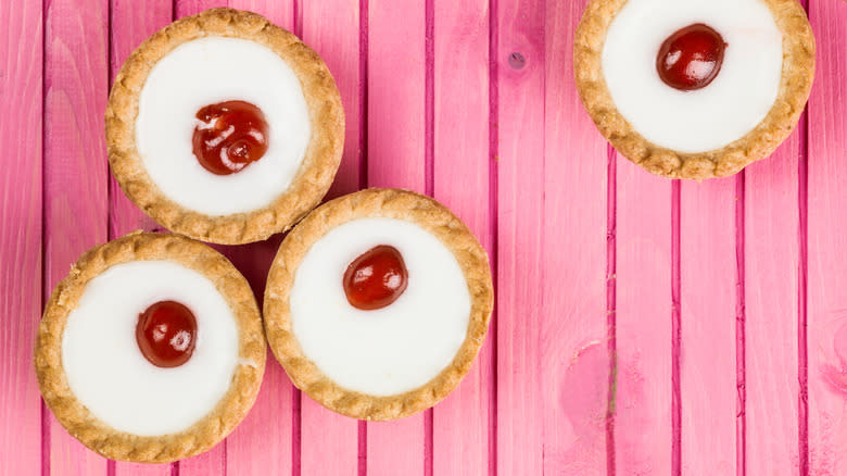 Bakewell tarts on pink wood