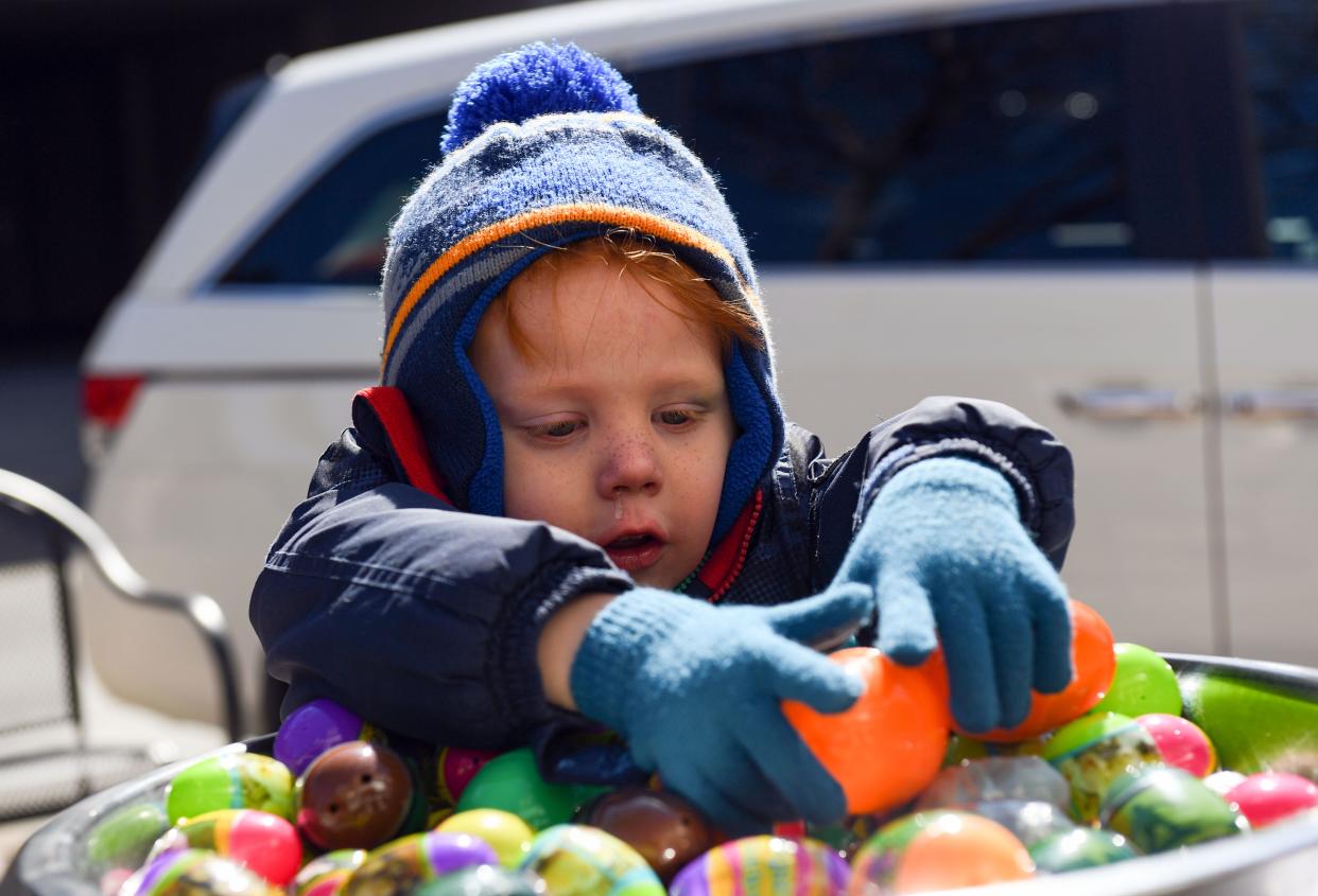Sebastian Dexter, 4, selects a plastic egg from a large bowl outside CH Patisserie during an Easter egg hunt on Saturday, April 16, 2022, in downtown Sioux Falls.