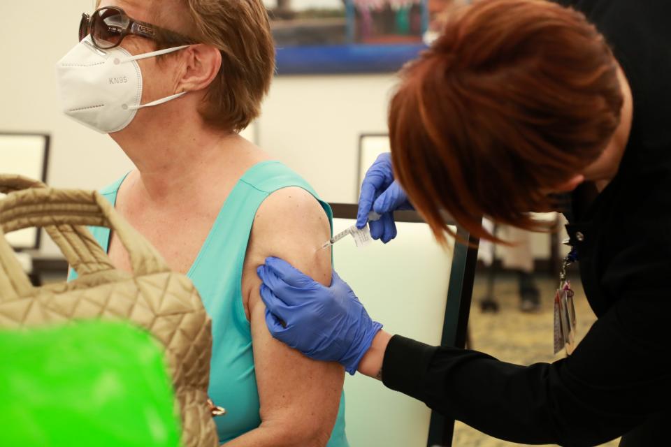 La Quinta resident Francis Rose, 83, receives the Pfizer COVID-19 vaccine from licensed practical nurse Callie Hatch at Eisenhower Health's clinic for patients age 75 and older on Tuesday, January 26, 2021, in Rancho Mirage, Calif.