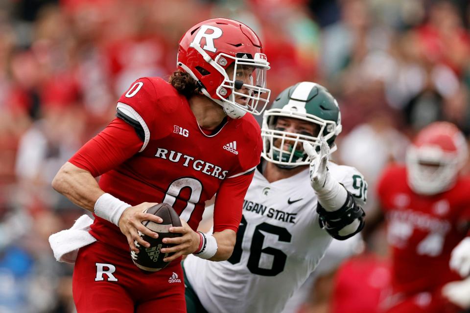 Rutgers quarterback Noah Vedral (0) gets away from a tackle attempt by Michigan State defensive end Jacub Panasiuk (96) during the second half of an NCAA college football game Saturday, Oct. 9, 2021, in Piscataway, N.J. Michigan State won 31-13.