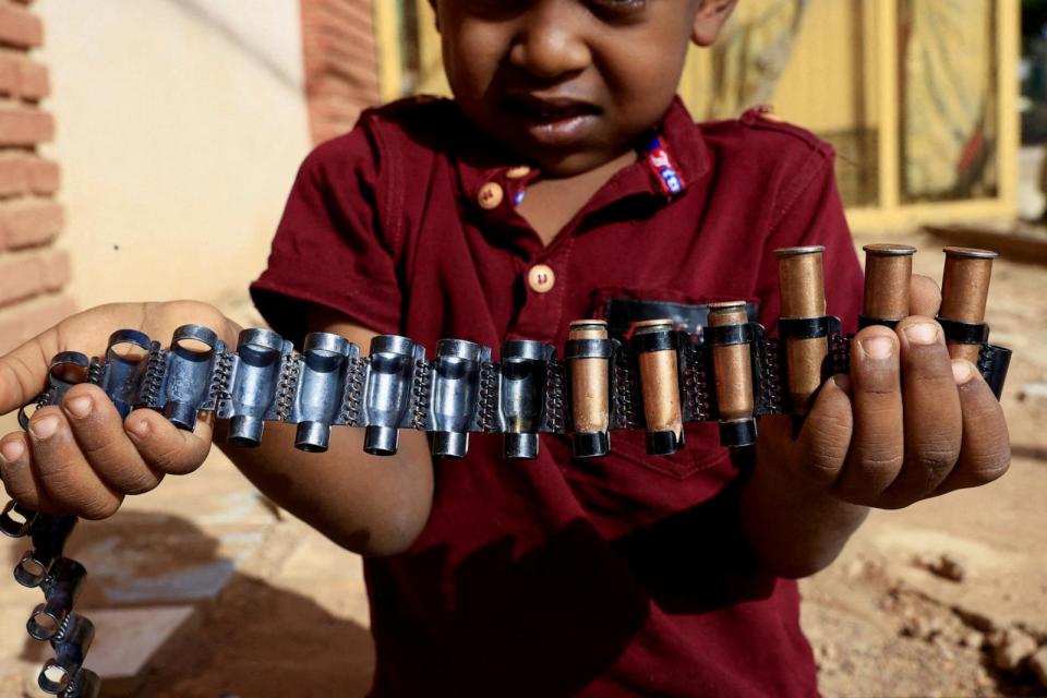PHOTO: A boy holds bullet cartridges as clashes between Sudan's paramilitary Rapid Support Forces (RSF) and the army continue, in Khartoum North, Sudan, May 13, 2023 (Mohamed Nureldin Abdallah/Reuters)