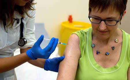 Volunteer Ruth Atkins receives an injection of the Ebola vaccine, at the Oxford Vaccine Group Centre for Clinical Vaccinology and Tropical Medicine (CCVTM) in Oxford, southern England September 17, 2014. REUTERS/Steve Parsons/Pool