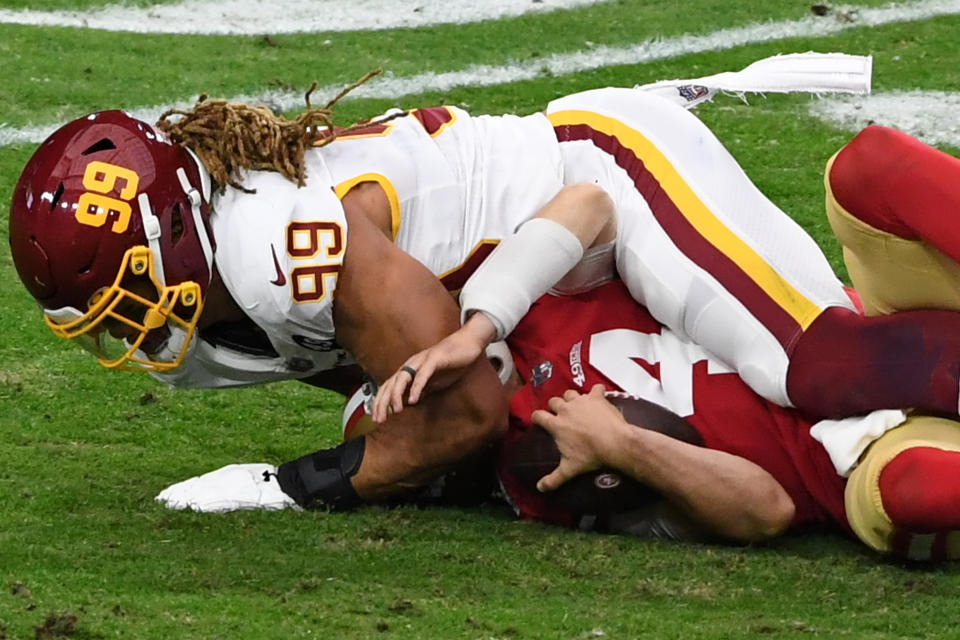 GLENDALE, ARIZONA - DECEMBER 13: Defensive end Chase Young #99 of the Washington Football Team sacks quarterback Nick Mullens #4 of the San Francisco 49ers during the first quarter of the game at State Farm Stadium on December 13, 2020 in Glendale, Arizona. (Photo by Norm Hall/Getty Images)