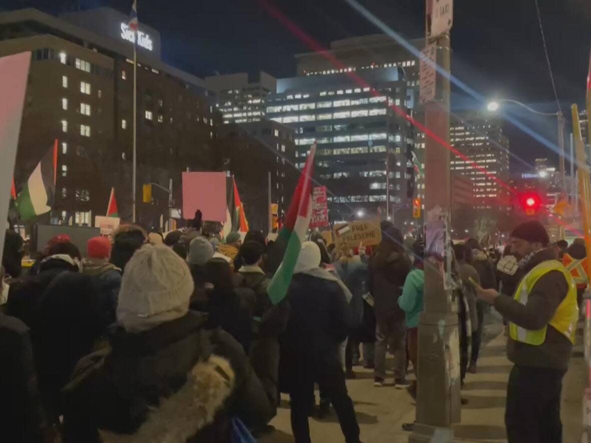Protesters seen here with Palestinian flags on hospital row Monday. Politicians including Prime Minister Justin Trudeau and Ontario Premier Doug Ford have denounced the protest. (Lorenda Reddekopp/CBC - image credit)