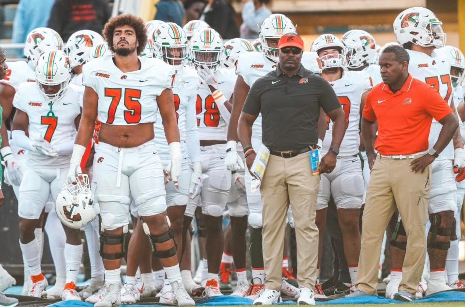 Florida A&M Rattlers head football coach Willie Simmons (black shirt) stands alongside his team before they take on the Southern Jaguars in a Southwestern Athletic Conference game at A.W. Mumford Stadium in Baton Rouge, Louisiana, Saturday, October 7, 2023.