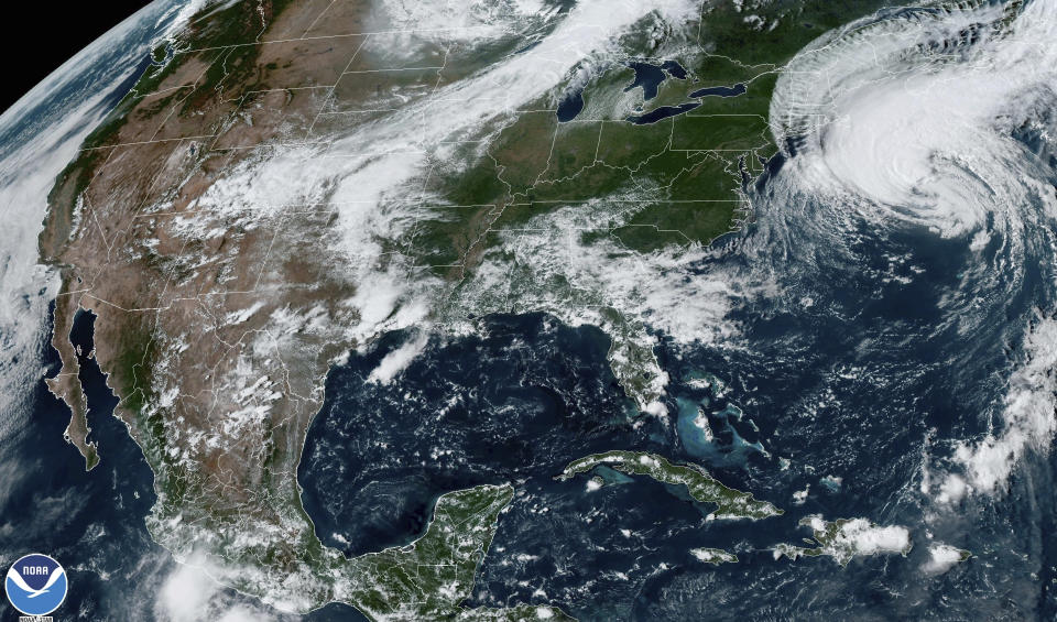 This Friday, Sept. 15, 2023, 4:06 p.m. EDT satellite image provided by the National Oceanic and Atmospheric Administration shows Hurricane Lee, right, near New England and Eastern Canada. A tropical storm warning extended from Maine through Massachusetts, with powerful gusts forecast to arrive late in the day in southern New England. Maine and coastal Nova Scotia and New Brunswick are expected to see the brunt of the storm's remnants on Saturday. (NOAA via AP)