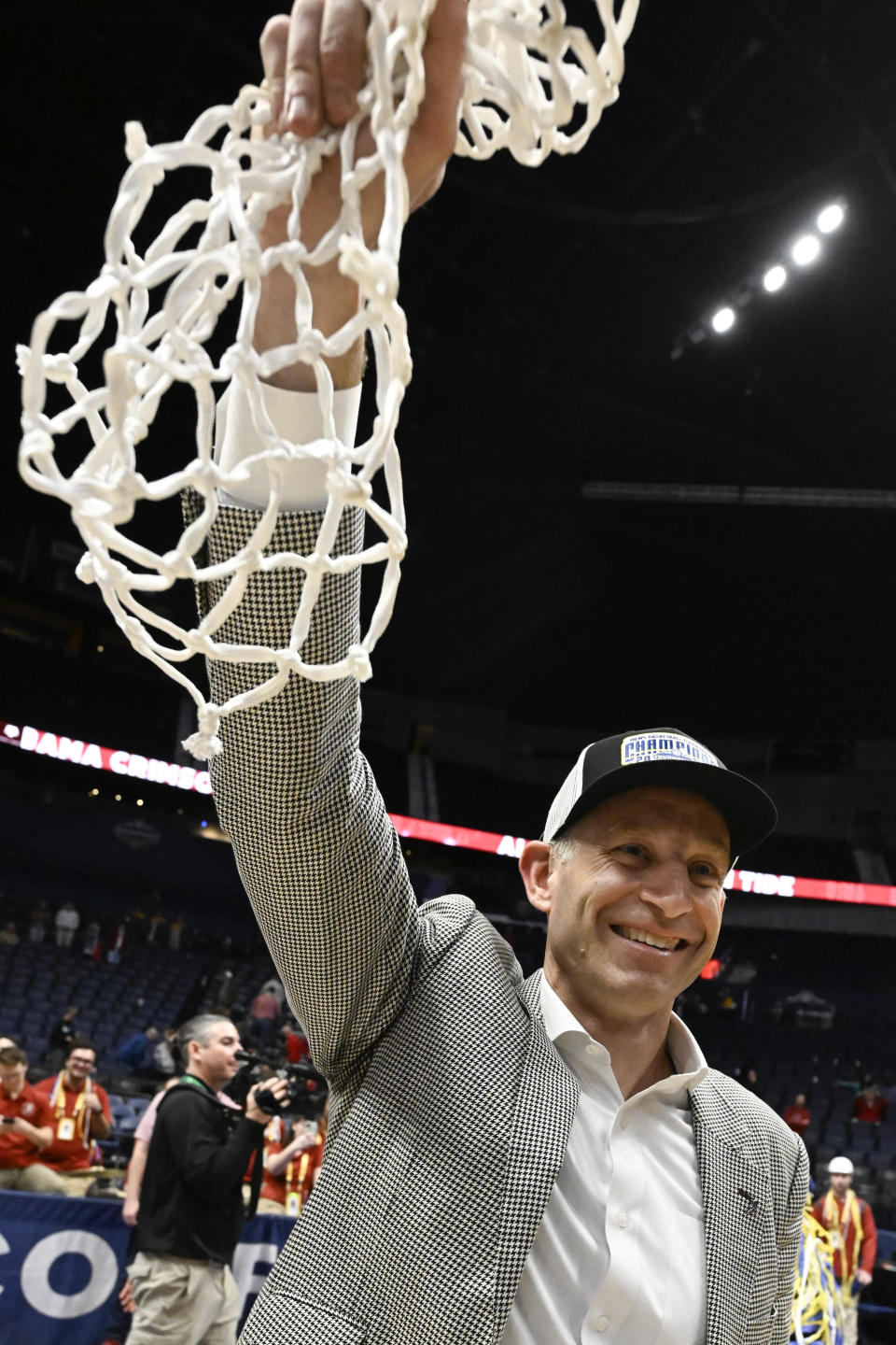 Alabama head coach Nate Oats holds up the net after an NCAA college basketball game against Texas A&M in the finals of the Southeastern Conference Tournament, Sunday, March 12, 2023, in Nashville, Tenn. Alabama won 82-63. (AP Photo/John Amis)