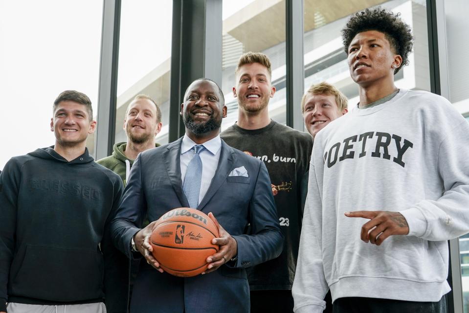 Milwaukee Bucks new head coach Adrian Griffin poses with players after he was introduced at a news conference Tuesday, June 6, 2023, in Milwaukee. (AP Photo/Morry Gash)