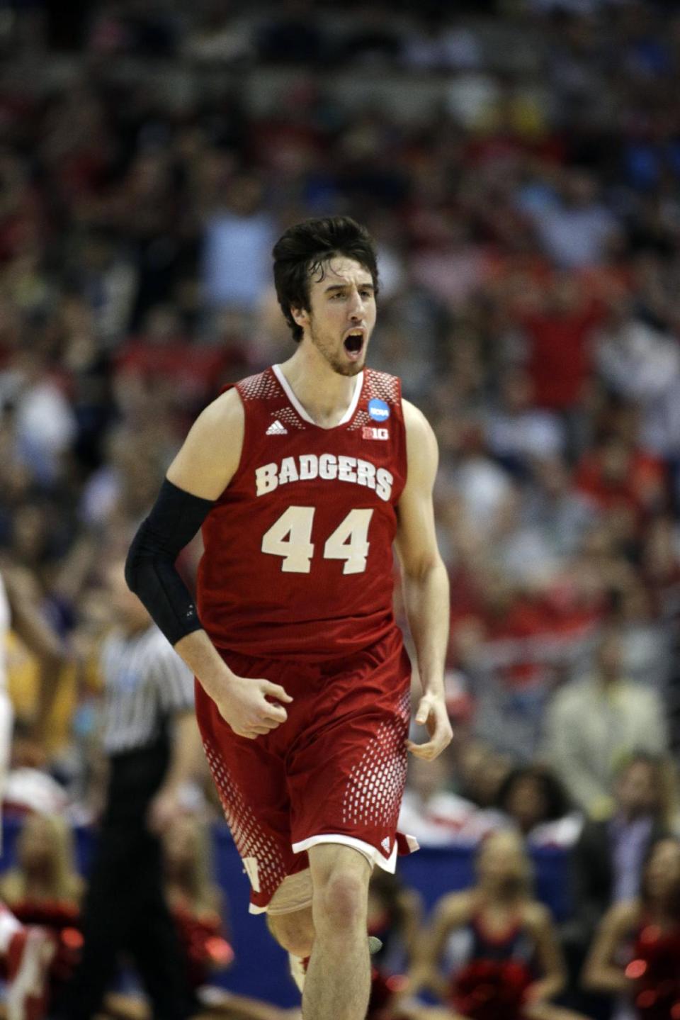 Wisconsin 's Frank Kaminsky reacts after making a shot during the first half in a regional final NCAA college basketball tournament game against Arizona, Saturday, March 29, 2014, in Anaheim, Calif. (AP Photo/Alex Gallardo)