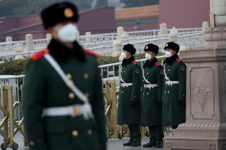 Paramilitary officers wearing face masks stand guard at the Tiananmen Gate, as the country is hit by an outbreak of the new coronavirus, in Beijing, China January 27, 2020. REUTERS/Carlos Garcia Rawlins