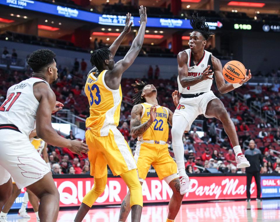 Louisville's Mike James looks to pass around the Pitt defense in the first half at the KFC Center Wednesday night. Jan. 18, 2023 